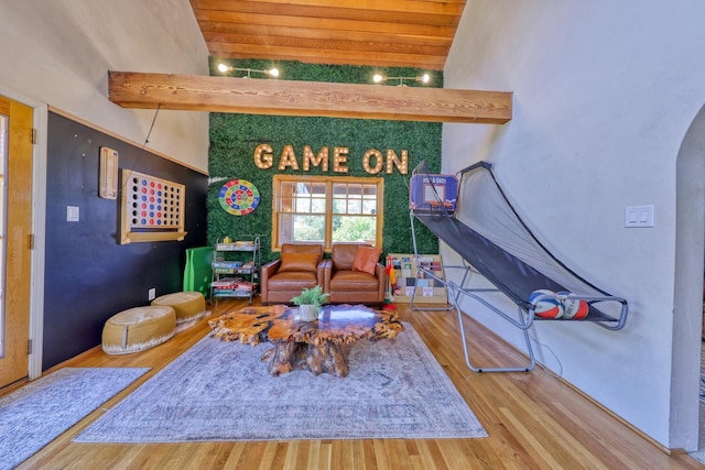 interior space with hardwood / wood-style floors and lofted ceiling with beams