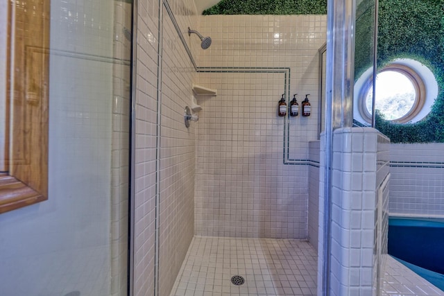 bathroom featuring a shower with door