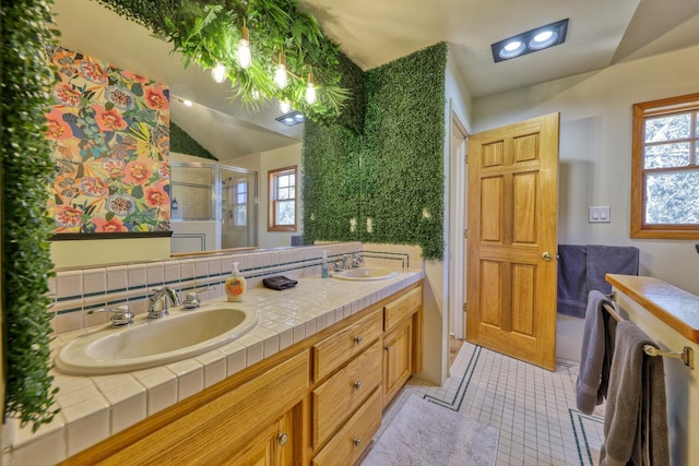 bathroom featuring tasteful backsplash, tile patterned floors, a shower with shower door, vanity, and lofted ceiling