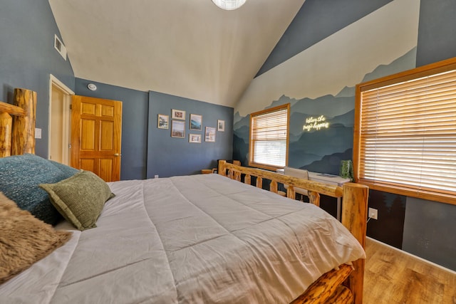 bedroom featuring hardwood / wood-style floors and lofted ceiling