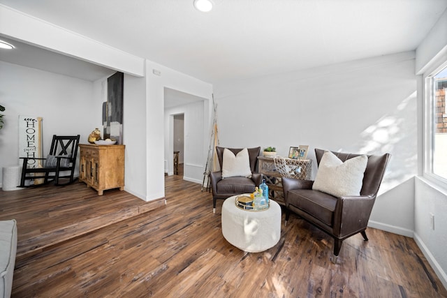 living area featuring dark wood-style flooring and baseboards