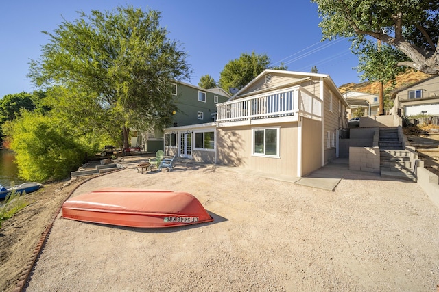 back of property featuring an outdoor fire pit and a patio area