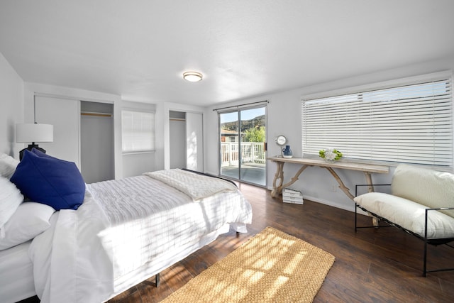 bedroom featuring access to exterior, baseboards, and dark wood-style flooring