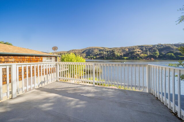 view of patio / terrace featuring a water and mountain view