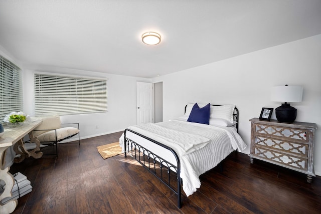 bedroom featuring dark wood finished floors and baseboards
