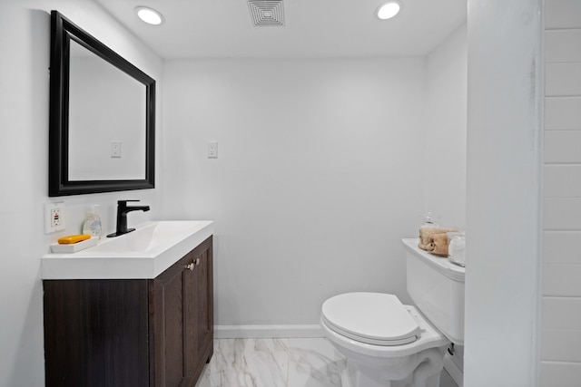 half bathroom with toilet, vanity, visible vents, baseboards, and marble finish floor