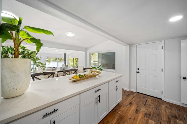 kitchen featuring recessed lighting, light countertops, dark wood-type flooring, white cabinetry, and baseboards