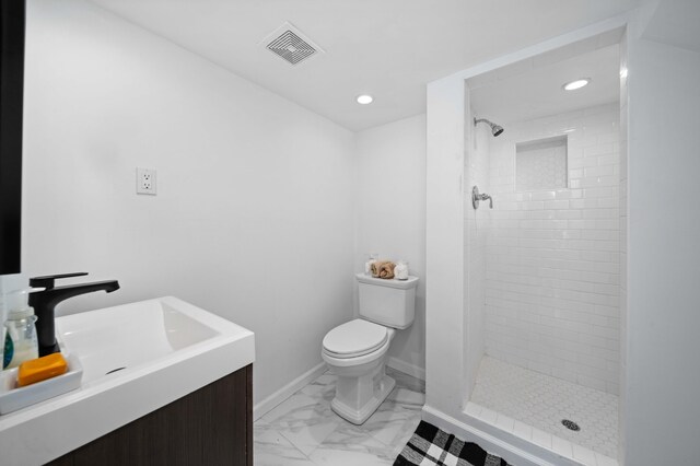 bathroom featuring visible vents, toilet, marble finish floor, vanity, and a shower stall