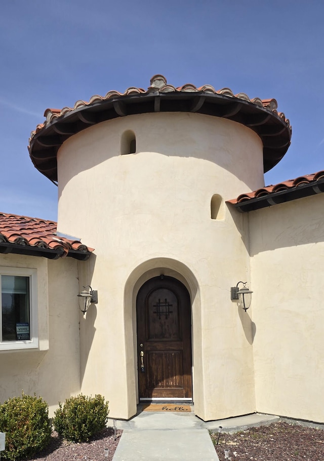 doorway to property featuring stucco siding