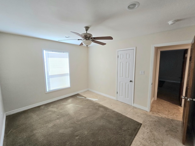 unfurnished bedroom with baseboards and a ceiling fan