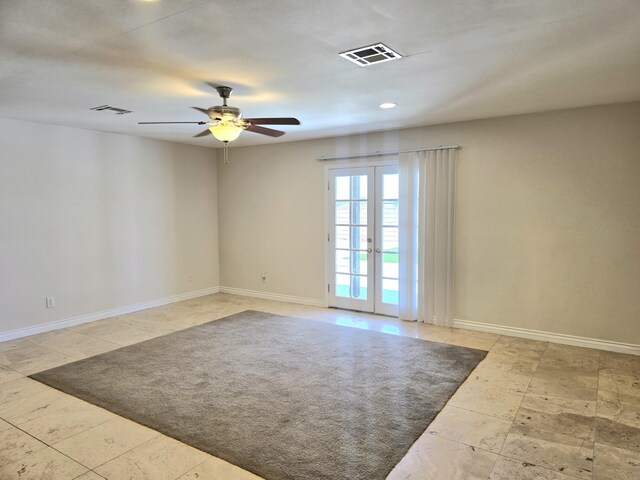 spare room featuring baseboards, ceiling fan, plenty of natural light, and beam ceiling