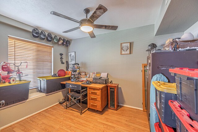 office featuring light wood-type flooring and ceiling fan