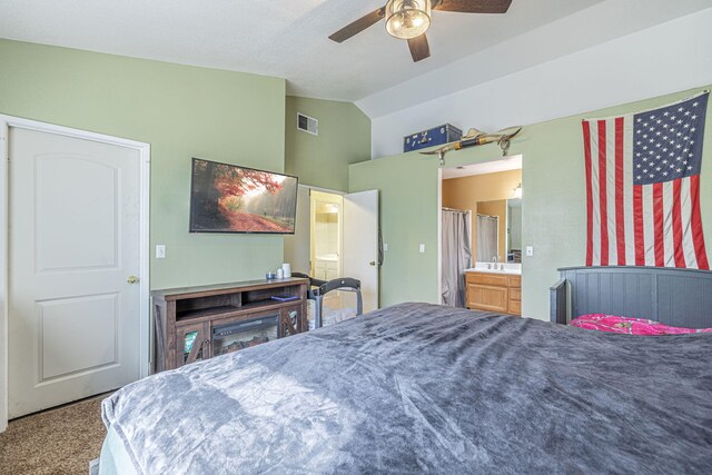 bedroom with sink, vaulted ceiling, ceiling fan, connected bathroom, and carpet floors