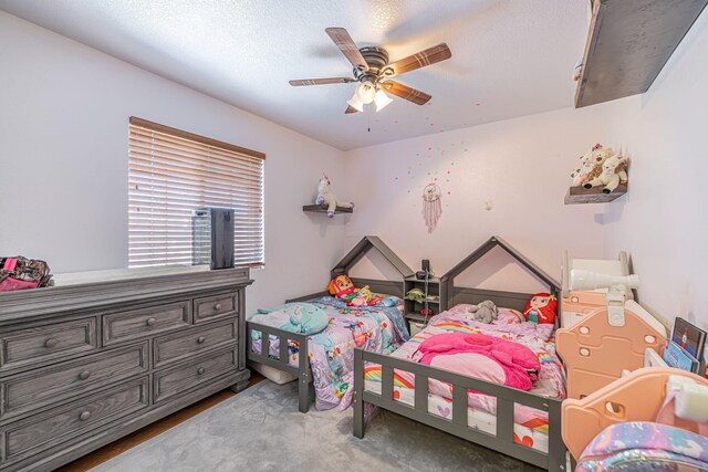 bedroom with a textured ceiling and ceiling fan