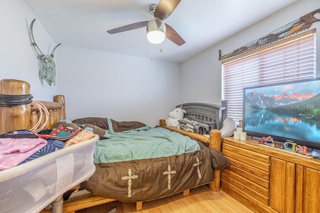 bedroom with ceiling fan and hardwood / wood-style flooring