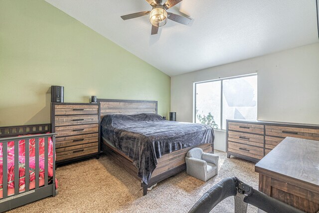 carpeted bedroom featuring ceiling fan and lofted ceiling