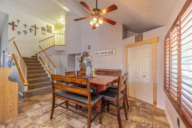 dining room featuring ceiling fan and high vaulted ceiling