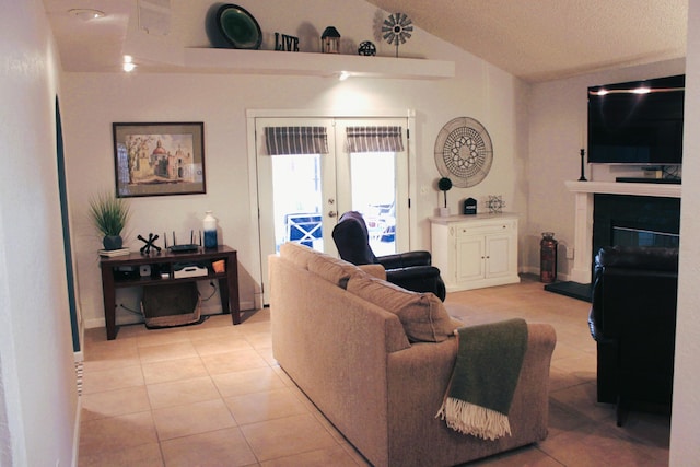 tiled living room with french doors and vaulted ceiling