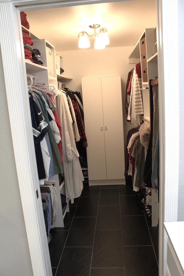 spacious closet featuring dark tile patterned floors