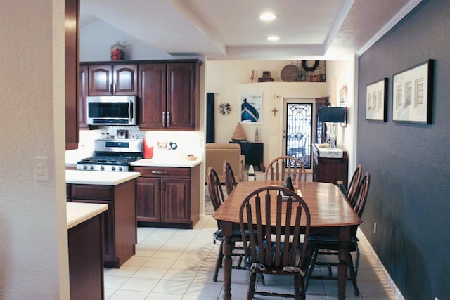 tiled dining area featuring crown molding