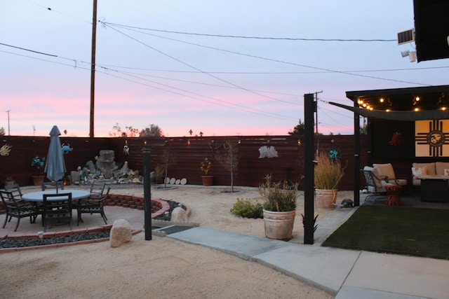 view of patio terrace at dusk