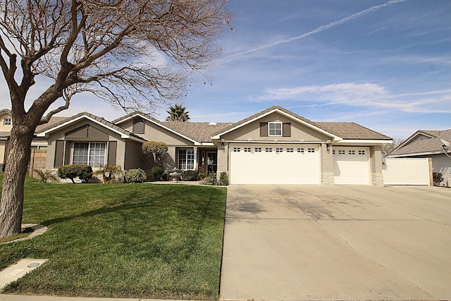 view of front of home with stucco siding, a front lawn, fence, concrete driveway, and a garage