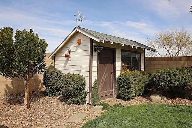 view of shed with fence