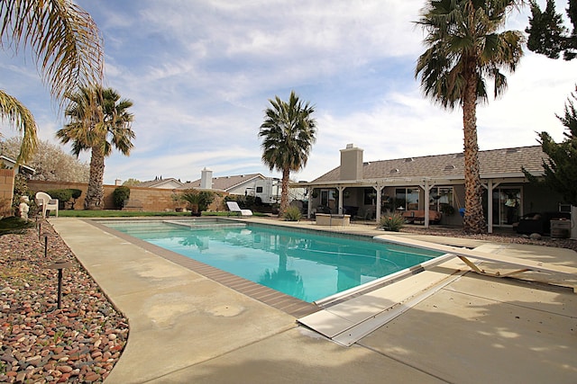 view of swimming pool with a fenced in pool, a patio, and a fenced backyard