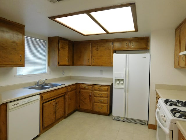 kitchen featuring white appliances and sink