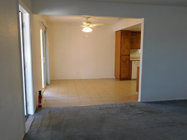 spare room featuring light tile patterned floors, plenty of natural light, and ceiling fan