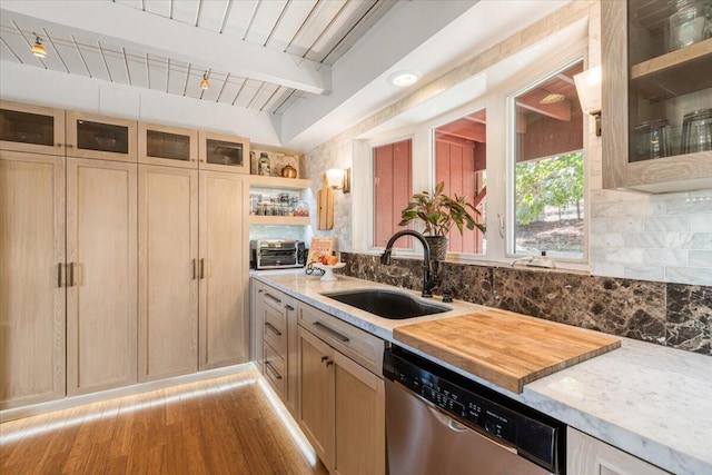 kitchen featuring tasteful backsplash, stainless steel dishwasher, wood ceiling, sink, and beam ceiling