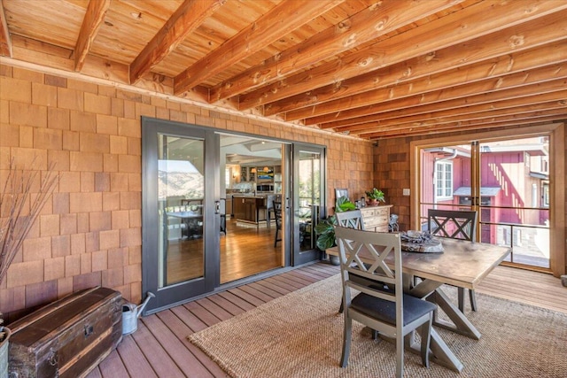 dining space featuring a wealth of natural light, hardwood / wood-style floors, beamed ceiling, and wooden ceiling