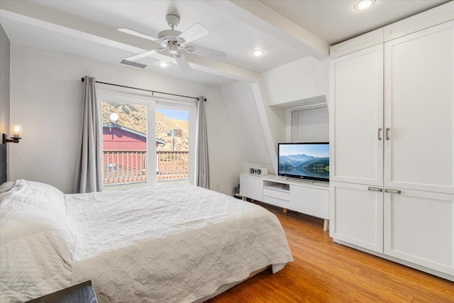 bedroom with beam ceiling, light wood-type flooring, and ceiling fan