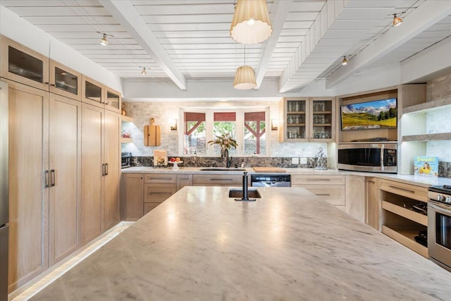 kitchen featuring light stone countertops, beamed ceiling, stainless steel appliances, and track lighting