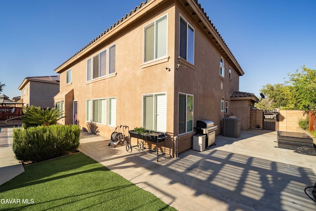 37331 E 57th St, Palmdale, CA 93552 - back of house featuring stucco siding, a patio area, a gate, and a tiled roof
