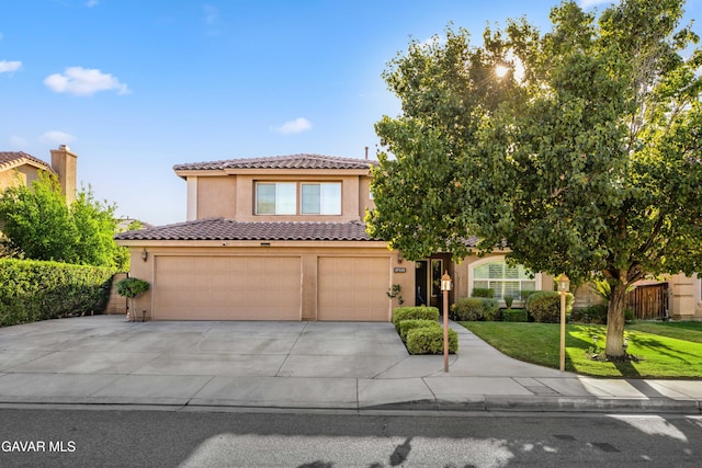 37331 E 57th St, Palmdale, CA 93552 - view of front of home with stucco siding, concrete driveway, a garage, a front yard, and a tiled roof