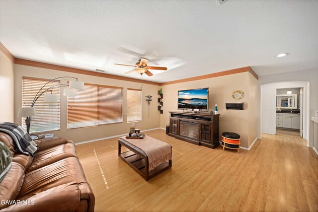 37331 E 57th St, Palmdale, CA 93552 - living room featuring light wood finished floors, a ceiling fan, and ornamental molding