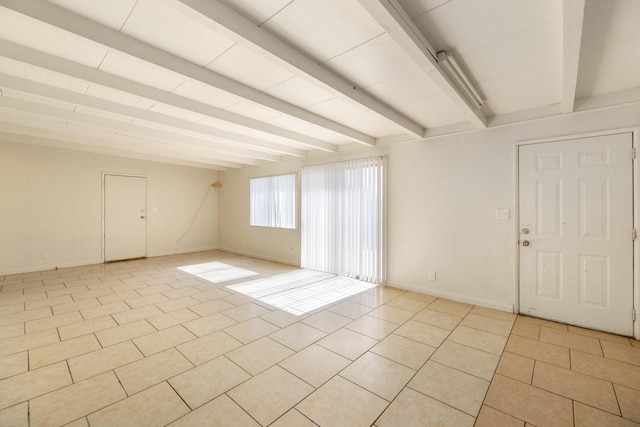 tiled empty room with beam ceiling