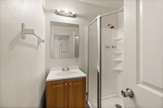 bathroom featuring vanity and an enclosed shower