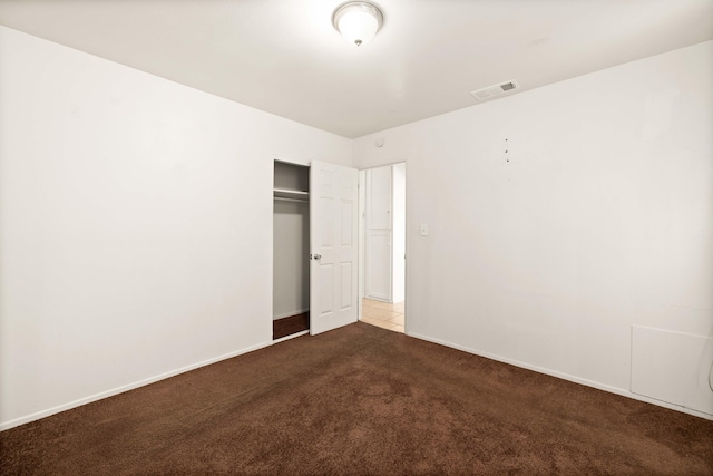 unfurnished bedroom with carpet and a closet