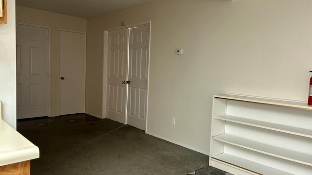 interior space featuring dark colored carpet