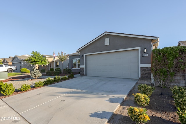 6116 Commonwealth Ave, Bakersfield, CA 93313 - ranch-style home featuring stucco siding, a garage, driveway, and stone siding