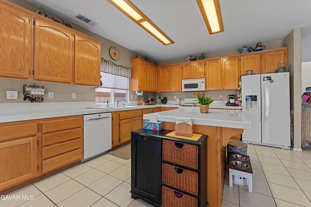 4148 Sungate Dr, Palmdale, CA 93551 - kitchen with white appliances, light tile patterned floors, tile countertops, and a center island
