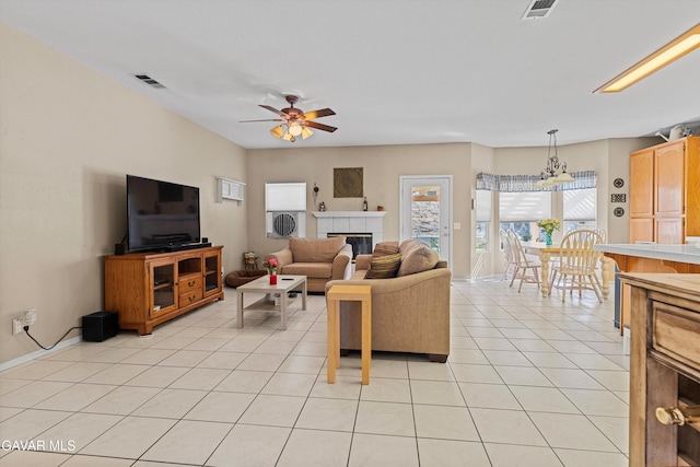 4148 Sungate Dr, Palmdale, CA 93551 - living room featuring a tile fireplace, a ceiling fan, light tile patterned flooring, and a chandelier