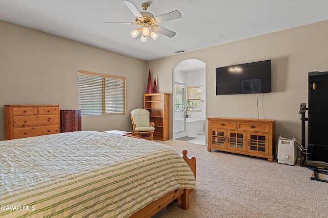 4148 Sungate Dr, Palmdale, CA 93551 - bedroom with carpet floors, arched walkways, ensuite bath, and ceiling fan