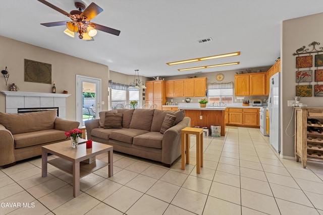 4148 Sungate Dr, Palmdale, CA 93551 - living area featuring ceiling fan, light tile patterned flooring, and a tiled fireplace