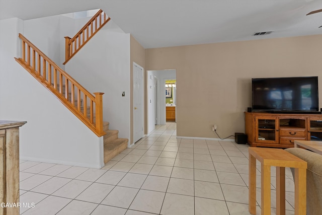 4148 Sungate Dr, Palmdale, CA 93551 - living area featuring stairway, light tile patterned floors, and a ceiling fan