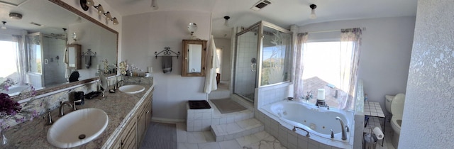 full bathroom featuring separate shower and tub, vanity, a healthy amount of sunlight, and toilet