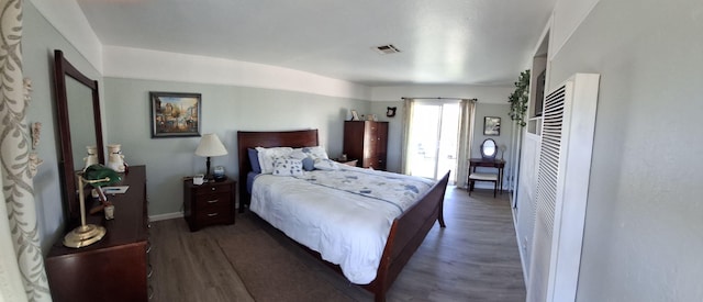 bedroom with dark wood-type flooring