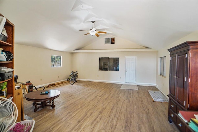 sitting room with ceiling fan, light wood-type flooring, and lofted ceiling